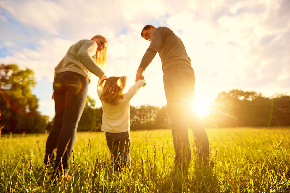 A couple and a child during sunset